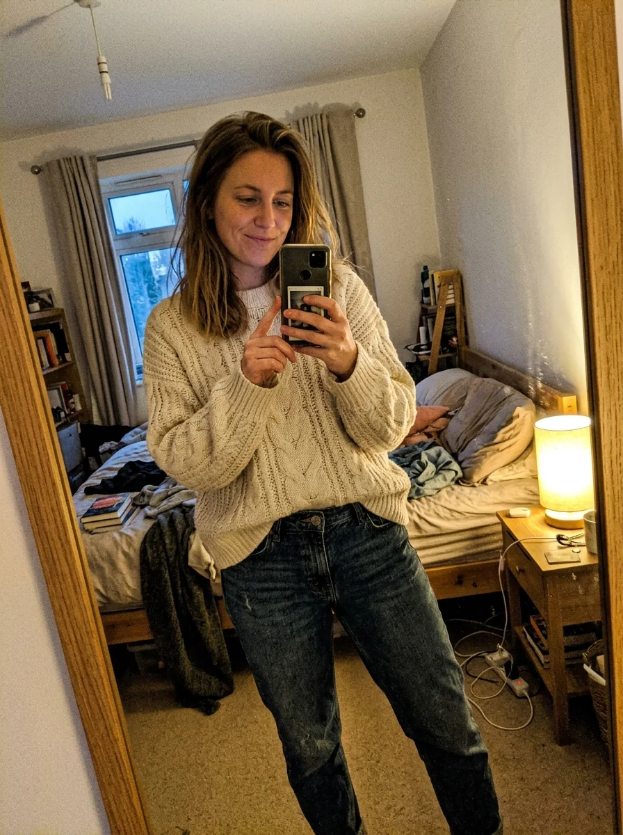 Woman wearing a cream cable-knit sweater